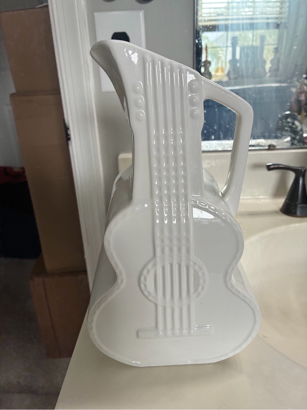 This piece is a Dolly Parton Signature Ceramic Guitar Pitcher.